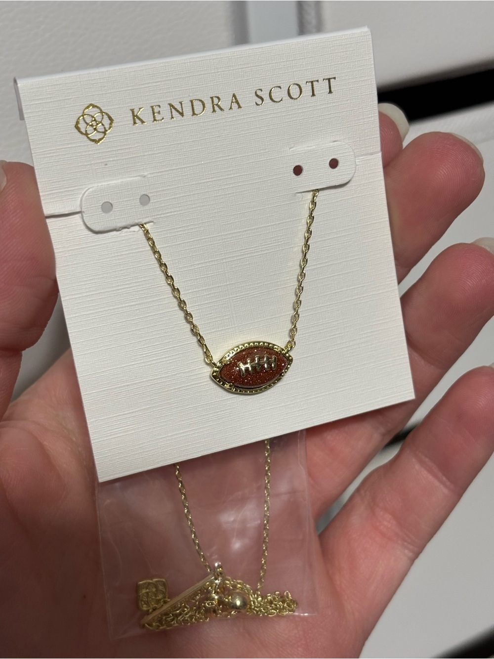 Kendra Scott Gold Necklace with Brown Glitter Football Pendant - Picture 3 of 3